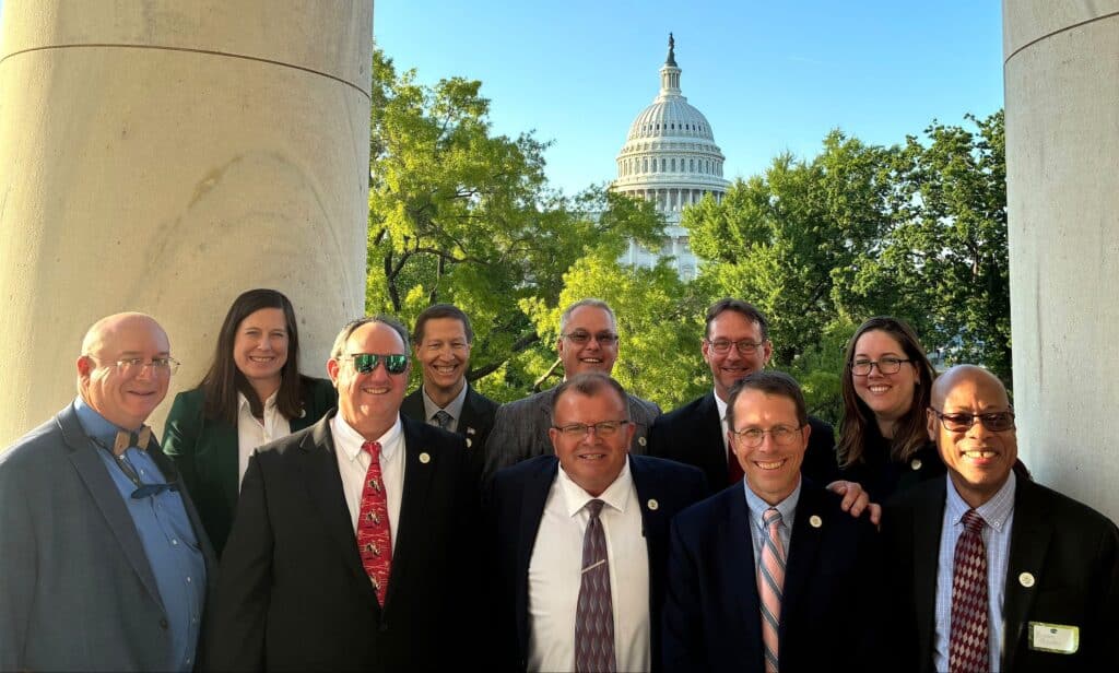 Group of Weed Science Society of America members standing outdoors in front of the U.S. Capitol building, showcasing professional collaboration in weed science research and advocacy.