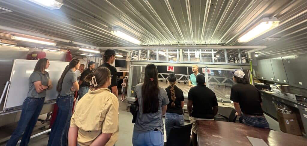 Group of people attending a presentation at the Weed Science Society of America event, focusing on weed management and research.